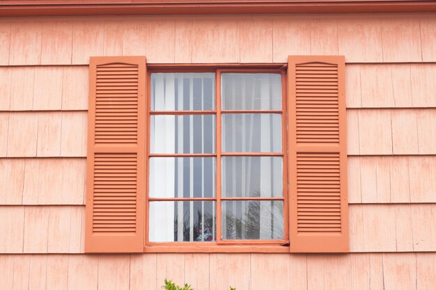 weatherboard cladding vintage window with orange tone wall